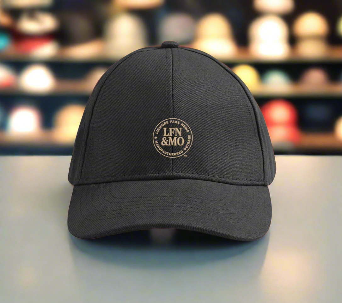Black cap with a logo on a blurred background of shelves with hats