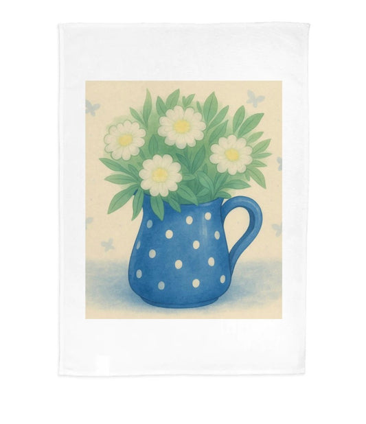 Blue polka dot pitcher with white flowers on a beige background