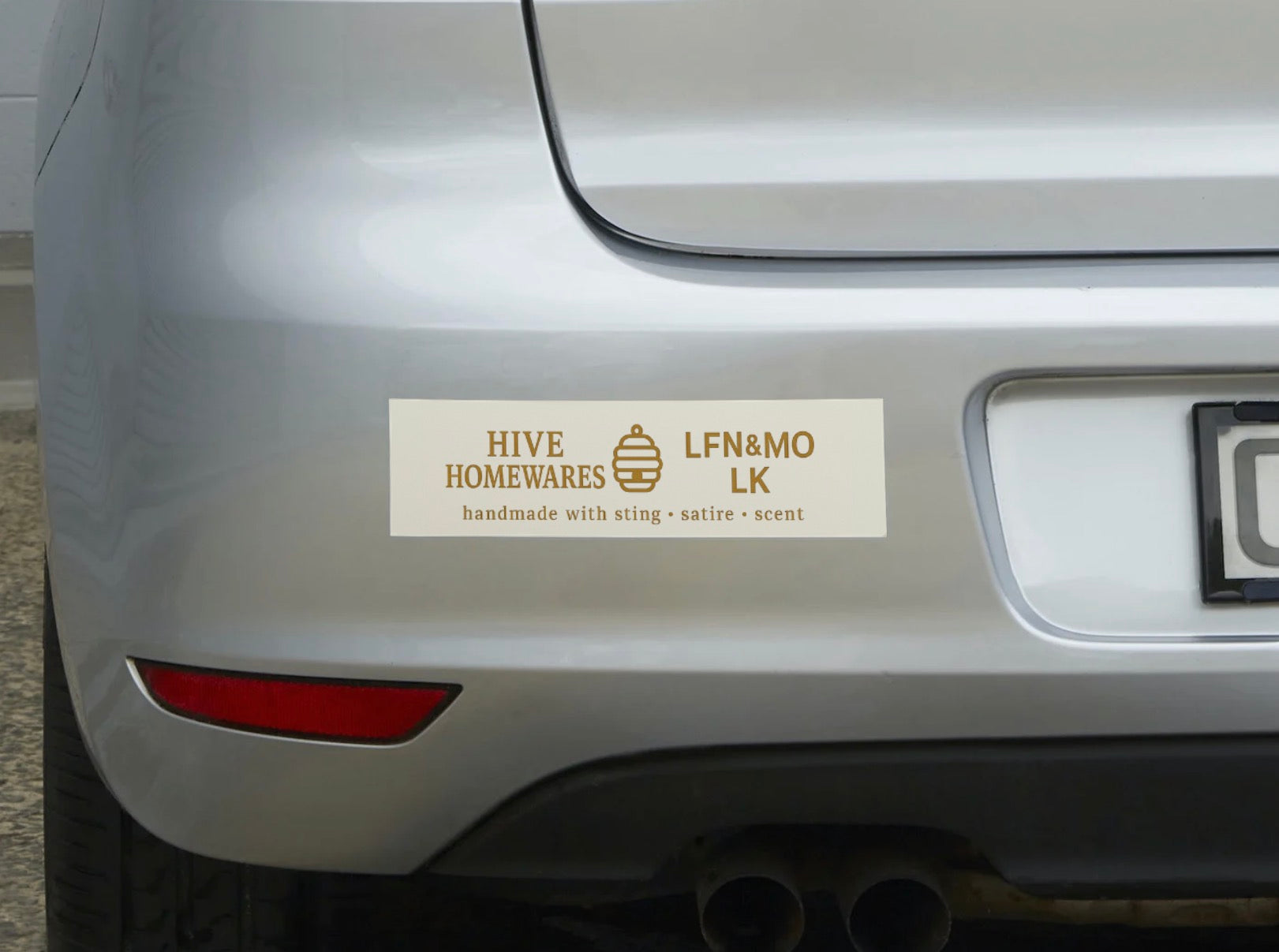 Bumper sticker on a car with text and logo