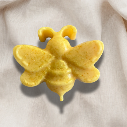 Yellow butterfly-shaped object on a light fabric background