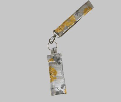 Floral patterned keychainwith a small pouch on a gray background