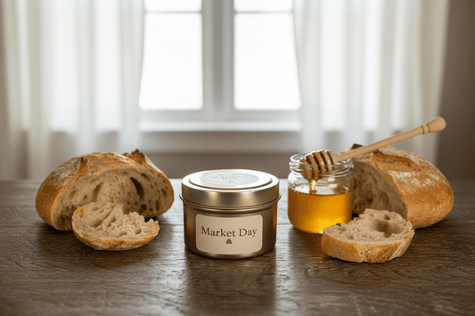 Beeswax blend candle on a table with bread and honey