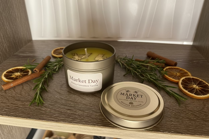 Beeswax blend Candle labeled 'Market Day' with cinnamon sticks and oranges on a wooden surface