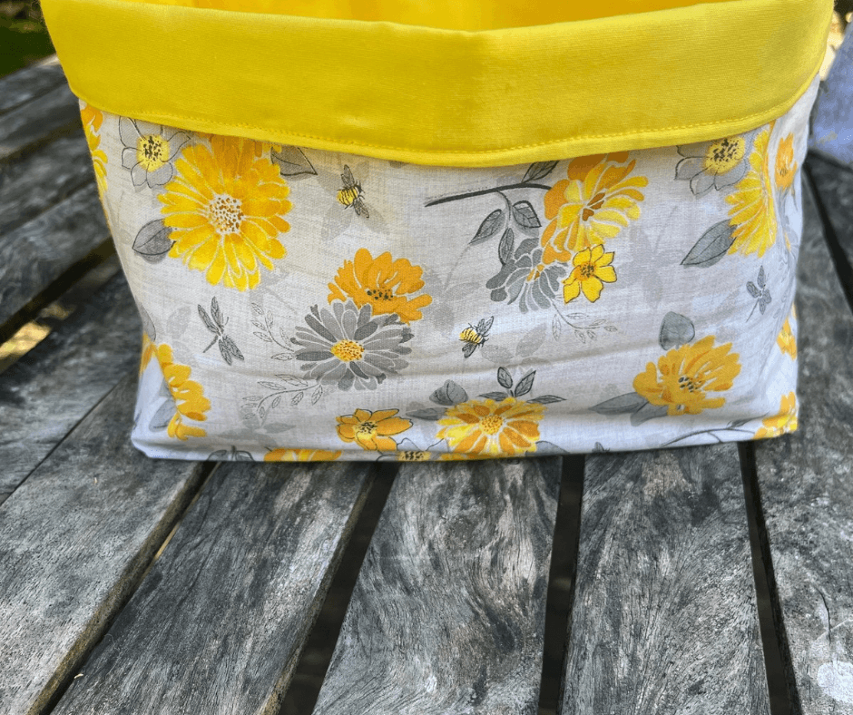Medium fabric tote bag from Lazy Daisy Collection featuring yellow floral design and a vibrant yellow top.