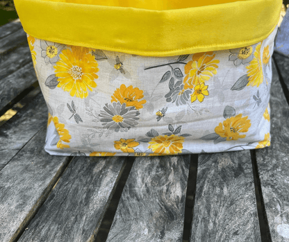 Medium fabric tote bag from Lazy Daisy Collection featuring yellow floral design and a vibrant yellow top.