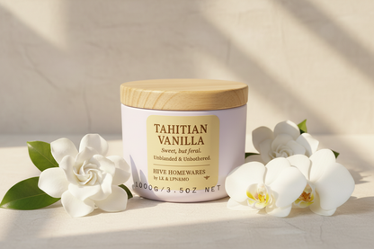 Vanilla candle white flowers sunlit pale background 